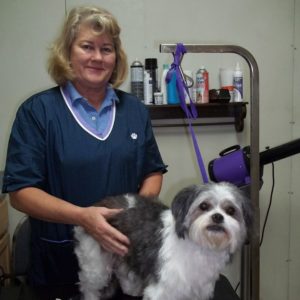 Cindy, professional groomer and RVH employee, posing for picture with freshly groomed dog
